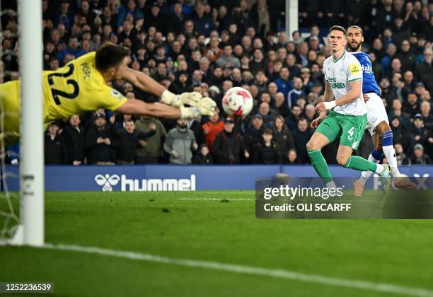 Newcastle United's English goalkeeper Nick Pope dives to save a shot from Everton's English striker Dominic Calvert-Lewin during the English Premier...