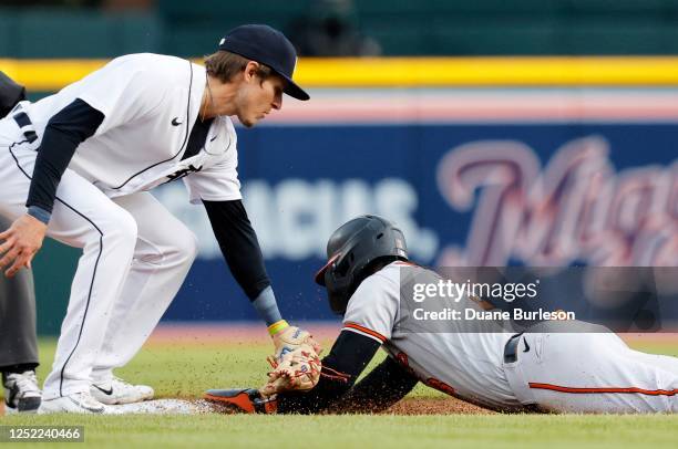 Jorge Mateo of the Baltimore Orioles beats the tag from shortstop Nick Maton of the Detroit Tigers to steal second base during the second inning at...
