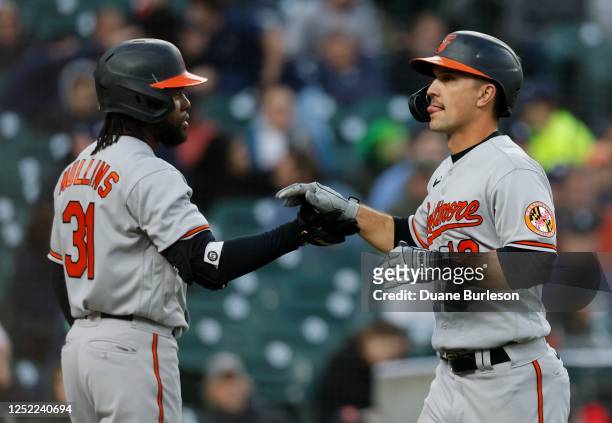 Adam Frazier of the Baltimore Orioles celebrates with teammate Cedric Mullins after scoring against the Detroit Tigers on a single by Joey Ortiz...