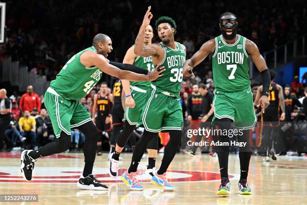 Marcus Smart of the Boston Celtics celebrates a play during the game against the Atlanta Hawks during Round 1 Game 6 of the 2023 NBA Playoffs on...