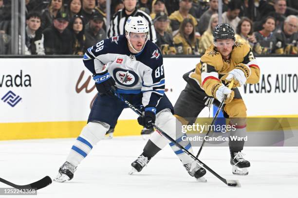 Nate Schmidt of the Winnipeg Jets protects the puck from Jack Eichel of the Vegas Golden Knights in the first period of Game Five of the First Round...