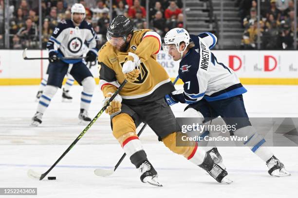 Alex Pietrangelo of the Vegas Golden Knights skates with the puck against Vladislav Namestnikov of the Winnipeg Jets in the first period of Game Five...