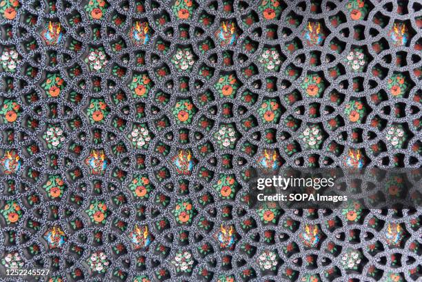 Wall frame decorated with Paper Mache is seen at a workshop in Srinagar. Papier-Mache handicrafts, is an age-old craft that was introduced to the...