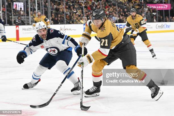 William Karlsson of the Vegas Golden Knights skates with the puck against Dylan DeMelo of the Winnipeg Jets in the second period in Game Five of the...