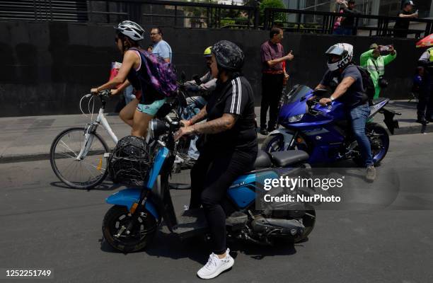 Motorcyclists try to circulate while street vendors in Mexico City block the Eje Central Lazaro Cardenas at the height of Juarez Avenue near the...