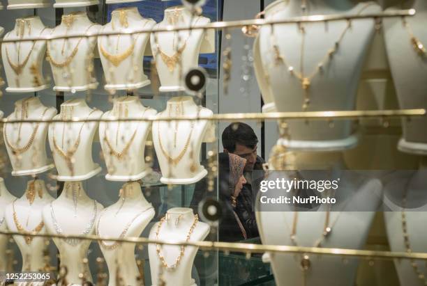 An Iranian couple shop at a gold and jewelry shop at the historical traditional bazaar in the city of Ardabil in Ardabil province, 617 km northwest...