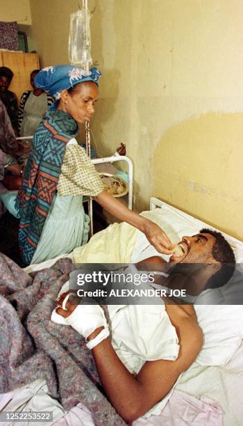 Wounded Eritrean soldier captured on Tuesday is fed by an Ethiopian woman at the Adigrat hospital 12 June, a day after an Eritrean MiG jet fighter...