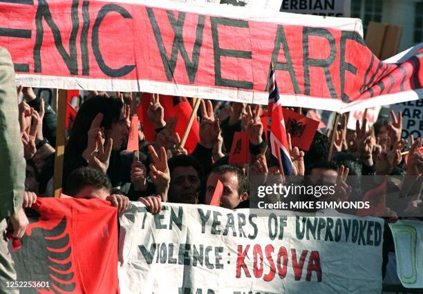 Demonstrators stand outside Lancaster House 09 March as senior diplomats from the six-power Contact Group are meeting for crisis talks on how to end...