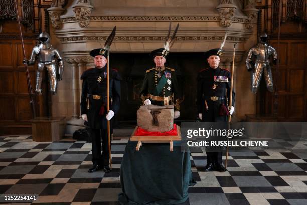 The Duke of Buccleuch Richard Scott , flanked by two members of The Royal Company of Archers, stands by the Stone of Destiny during a special...
