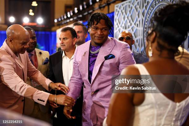 Jalen Carter reacts in the green room backstage after receiving news that he will be drafted by the Philadelphia Eagles during the first round of the...