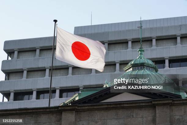 The Japanese national flag is seen at the Bank of Japan headquarters in Tokyo on April 28, 2023.
