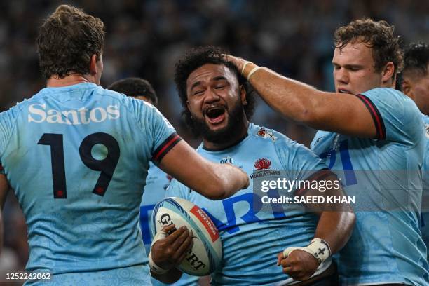 The Waratahs' Mahe Vailanu celebrates with his teammates after scoring a try during the Super Rugby match between the New South Wales Waratahs and...