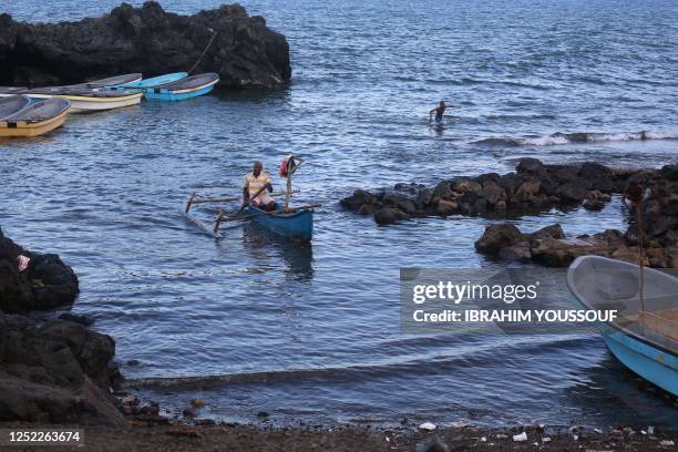 A fisherman steers a timber boat called kwassa kwassa towards the beach in Domoni, on the Anjouan island in the Comoros Archipelago on April 27,...