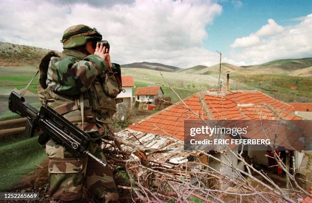 French NATO soldier observes the Yugoslav army positions 14 April 1999 at the border between Macedonia and Yugoslavia. NATO soldiers have reinforced...