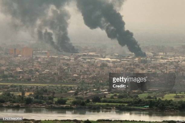 This image grab taken from AFPTV video footage on April 28 shows an aerial view of black smoke rising over Khartoum. - Fighting raged in Sudan,...