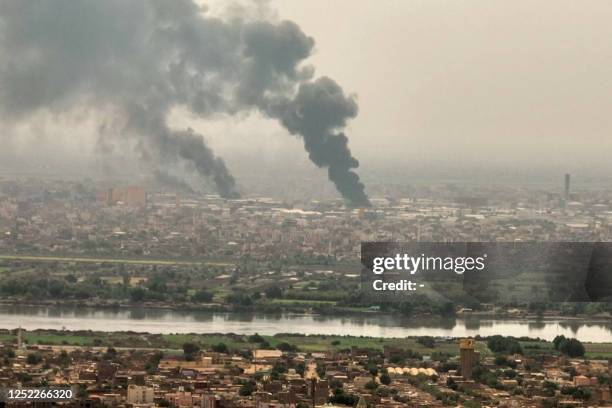 This image grab taken from AFPTV video footage on April 28 shows an aerial view of black smoke rising over Khartoum. - Fighting raged in Sudan,...