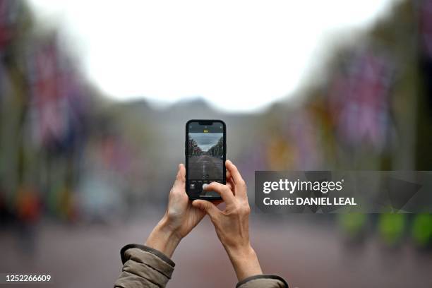 Photograph is taken on a smart phone on The Mall, in central London, on April 28, 2023 ahead of the coronation ceremony of Charles III and his wife,...