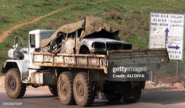 Military truck carries the wreckage of Israeli General Erez Gerstein's car that was blown up by members of the pro-Iranian Hezbollah movement with a...