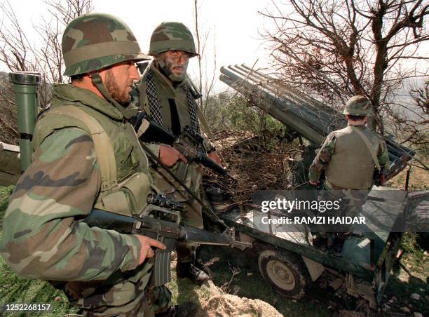 Pro-Iranian Hezbollah militants display a multi-rocket launcher in the Iqlim at-Touffah region near the self-declared Israeli security zone in south...