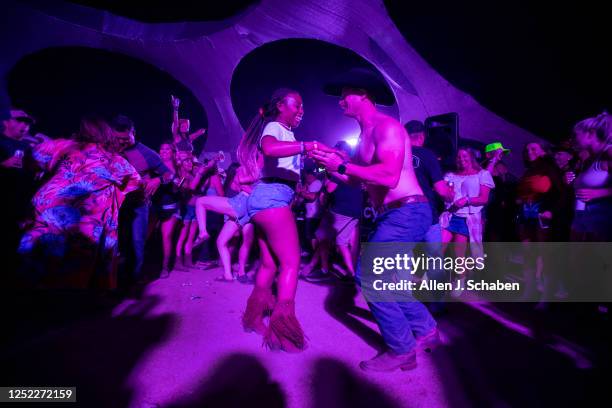 Country music fans dance at the K-Frog & KSON Dance Party in the Dome at the three-day Stagecoach Country Music Festival at the Empire Polo Club in...