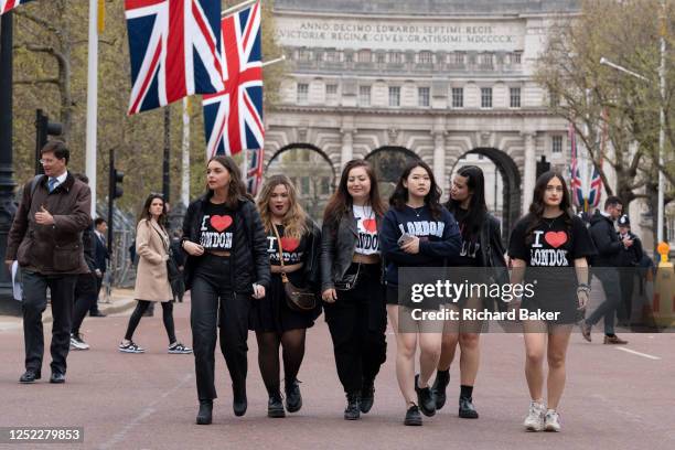 With Admiralty Arch behind them, a group of young women wearing 'I Love London' t-shirts march confidently down the Mall, on 26th April 2023, in...