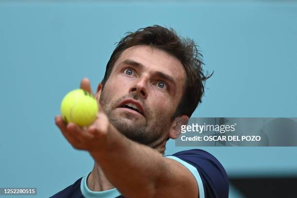 France's Quentin Halys serves to Spain's Roberto Bautista Agut during their 2023 ATP Tour Madrid Open tennis tournament singles match at the Caja...