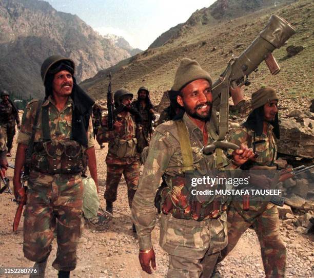 Indian troops march towards a forward position in the Drass sector of Indian Kashmir which was captured by Islamic guerrillas 29 June 1999. Twenty...