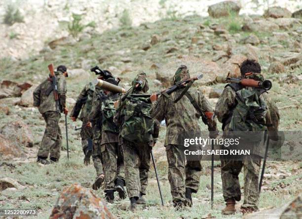 Group of Hizb-ul-Mujahideen millitants proceed for an operation against Indian troops in the Kargil sector of the Indian-controlled Kashmir, 30 June...