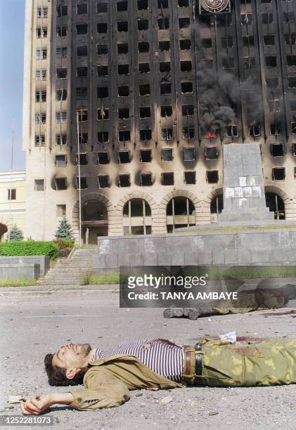 Georgian soldier killed during the battle for Sukhumi lay in front of the burning parliament building in Sukhumi 28 September 1993. The Abkhazian...