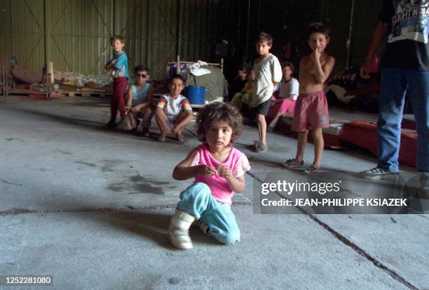 Young Tsiganes wait in a warehouse, 27 June 1999, in Leposavic, north of Kosovo, in a Yugoslavian Red Cross camp, where 600 "Roms" considered as...