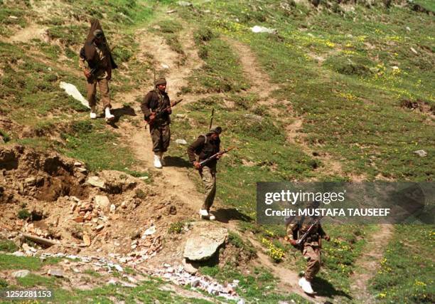 Indian Army Infantry trek down a ridge near Tigar hills in Drass Sector where a fierce battle is going on between Indian troops and Pakistani backed...