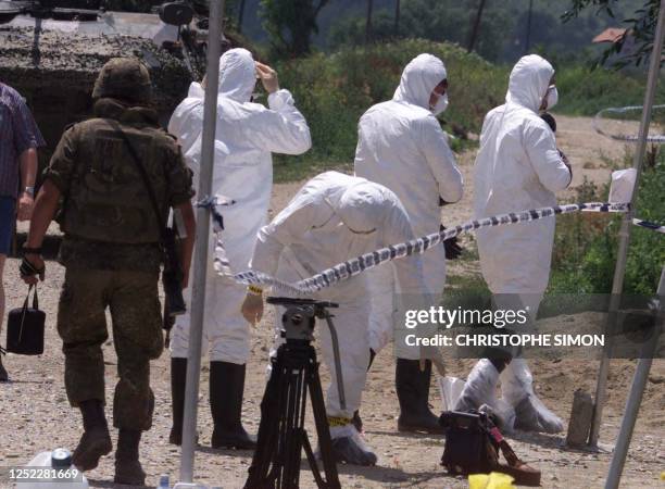 Scotland Yard forensic team enters the Kosovar village of Velika Kruca, 20 kilometers outside Prizren, where several bodies were found amid traces of...