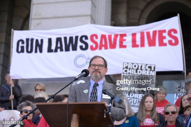 Tom Mauser, father of Columbine High School shooting victim Daniel Mouser, and gun control bill supporters gather after Gov. Jared Polis signed four...