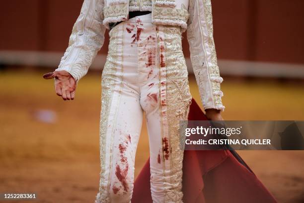 French torero Sebastian Castella's costume stained with blood is seen after killing a bull during a bullfight in La Maestranza bullring in Seville on...