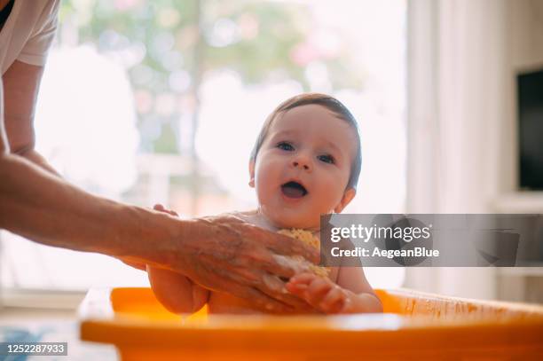 baby boy having bath in the living room in bathtub - hot babe stock pictures, royalty-free photos & images