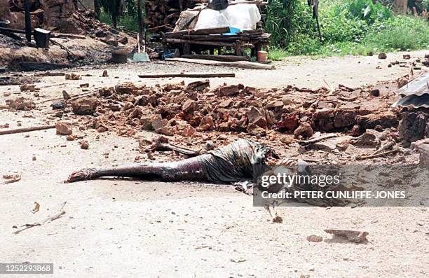 The body of a woman lies in an alleyway in the town of Odi, southern Nigeria, 02 December 1999. A resident told AFP the woman was her sister, named...