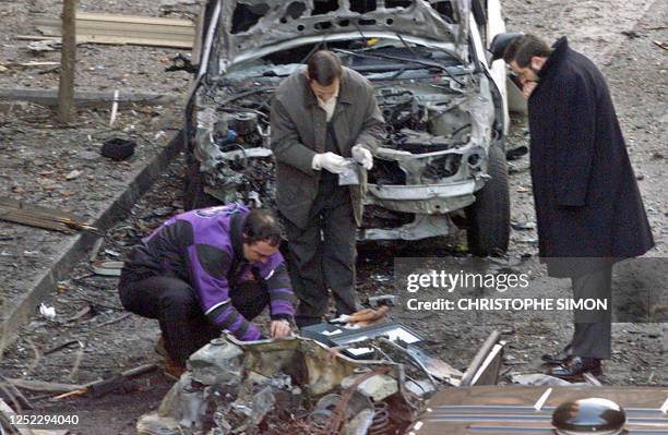 Policemen searching for evidence on the site of the car bomb explosion which killed Spanish army officer Pedro Antonio Blanco Garcia, at central...