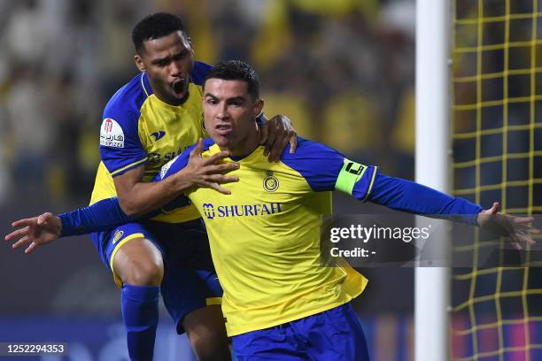 Nassr's Portuguese forward Cristiano Ronaldo celebrates scoring his team's first goal during the Saudi Pro League football match between Al-Nassr and...