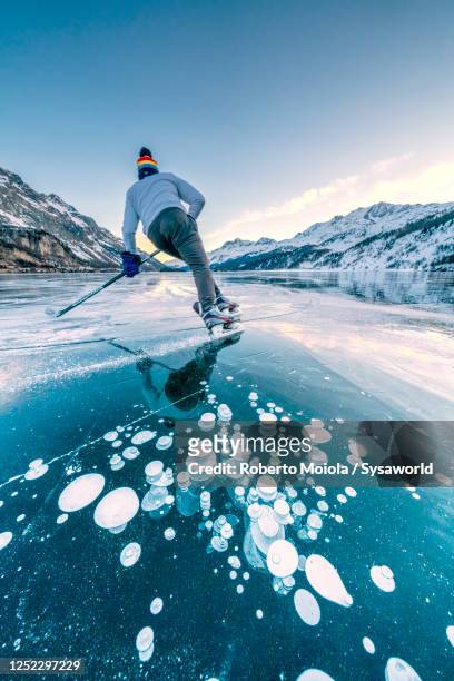 ice hockey player skating at lake sils, switzerland - ice hockey player back turned stock pictures, royalty-free photos & images