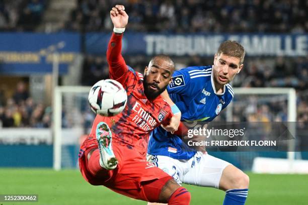 Strasbourg's French defender Maxime Le Marchand fights for the ball with Lyon's French forward Alexandre Lacazette during the French L1 football...
