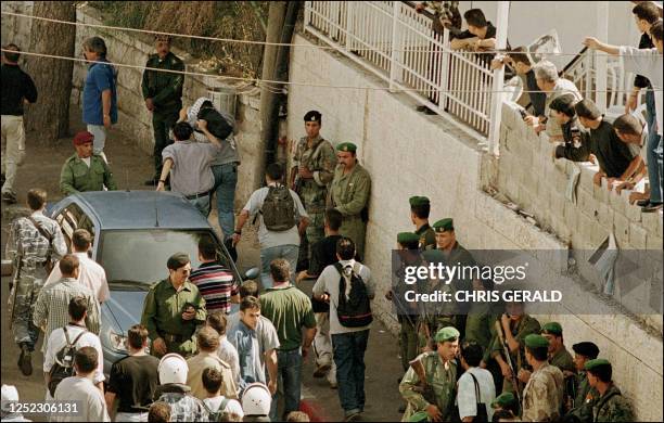 Palestinian grabs an undercover Israeli soldier in the West Bank town of Ramallah 12 October 2000. Two Israeli soldiers were killed by a furious...