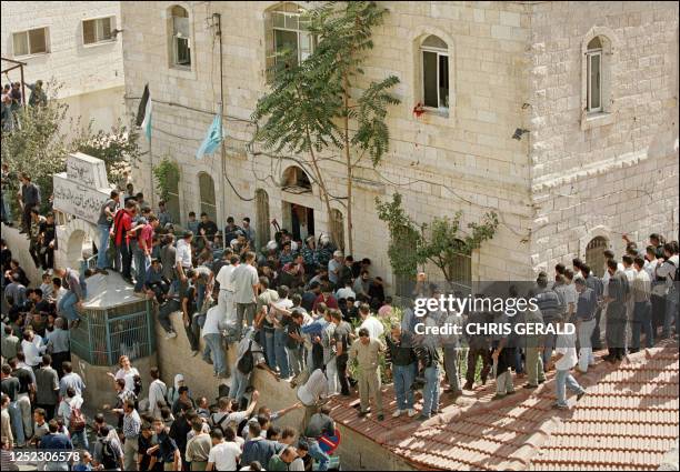 Palestinians lynch an undercover Israeli soldier inside the compound of a police station in the West bank town of Ramallah 12 October 2000. Israeli...