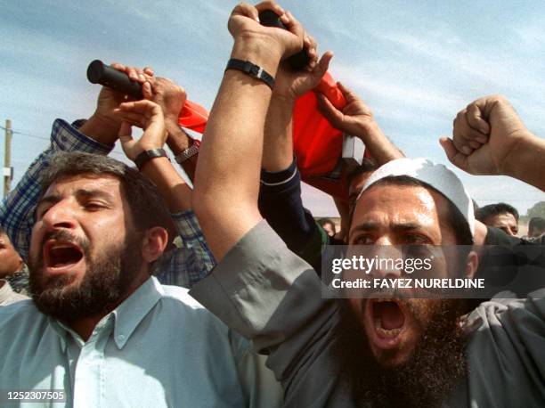 Palestinian mourners shout anti-Israel slogans during the funeral of Sami Abu Jazar in Rafah City in the Gaza Strip 12 October 2000. Jazar was shot...