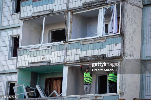 Utility workers repair the balconies of an apartment building damaged by a blast wave caused by a Russian missile in Uman district located in...