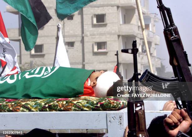 The body of Sami Abu Jazar is carried through the streets of Rafah City in the Gaza Strip 12 October 2000. Jazar was shot dead by Israeli forces...