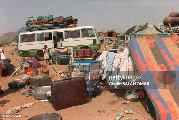 An Eritrean girls stands amid furniture and other personal belongings at the Laffa refugee camp near the eastern Sudanese town of Kassala 01 June...
