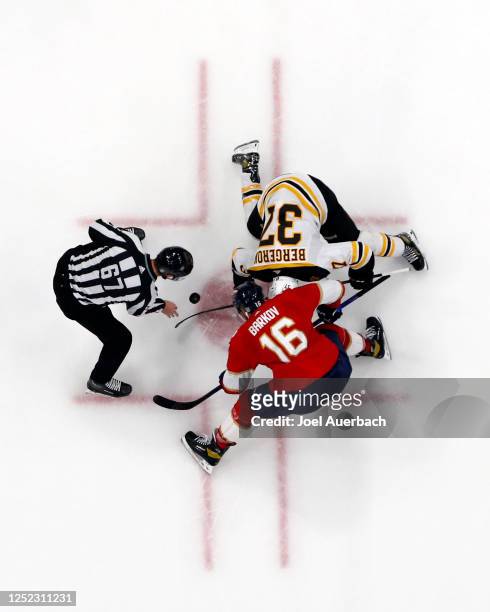 Linesman Travis Gawryletz drops the puck between Patrice Bergeron of the Boston Bruins and Aleksander Barkov of the Florida Panthers during third...