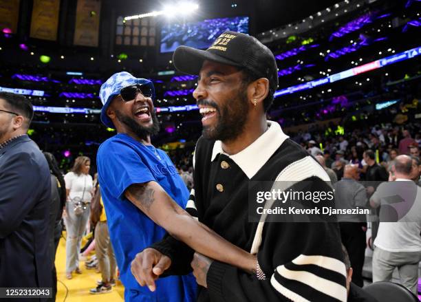 Tee Morant, father of Ja Morant of the Memphis Grizzlies, and Kyrie Irving of the Dallas Mavericks attends a basketball game between Los Angeles...