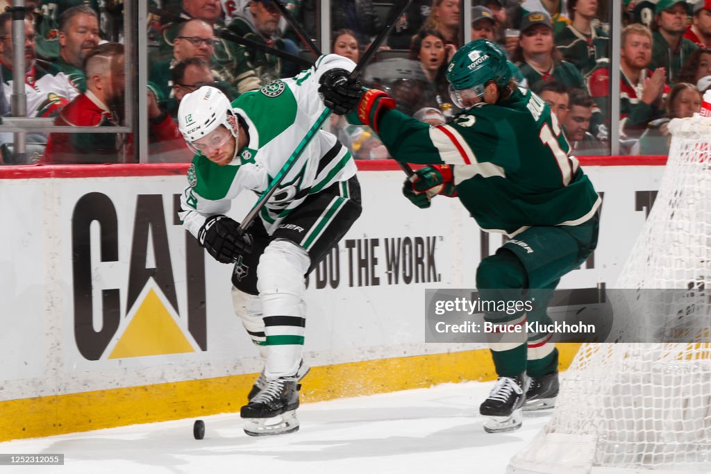 Matt Radek Radek Faksa of the Dallas Stars and Matt Boldy battle of the puck the ...