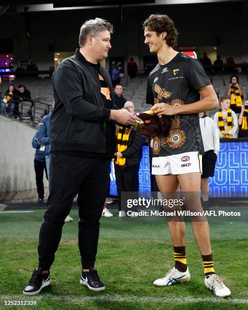 Robert Campbell presents Max Ramsden of the Hawks with his first jumper during the 2023 AFL Round 07 match between the Western Bulldogs and the...